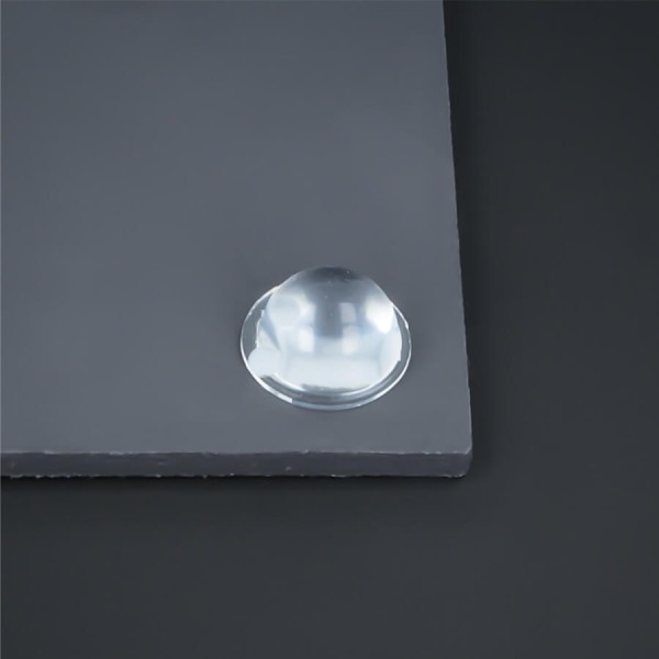 Bumpon Elastik-Wand-Puffer transparent selbstklebend Ø 16 mm auf dunkler Platte montiert